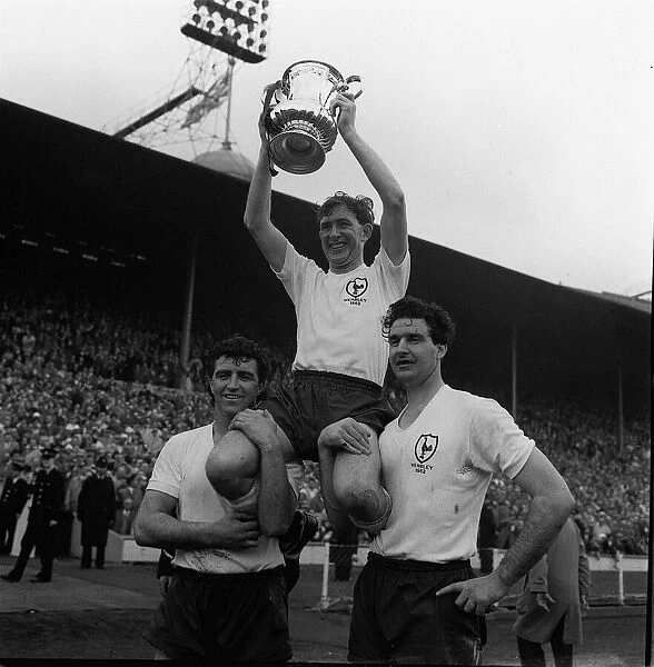 Danny Blanchflower of Tottenham holds up FA Cup May 1962 with Bobby Smith Maurice