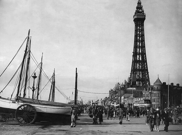 Day trippers enjoying the sea air with a walk along Blackpool