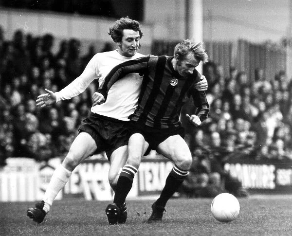 Dennis Law December 1973 of Manchester United (R) in action with Spurs Terry Naylor