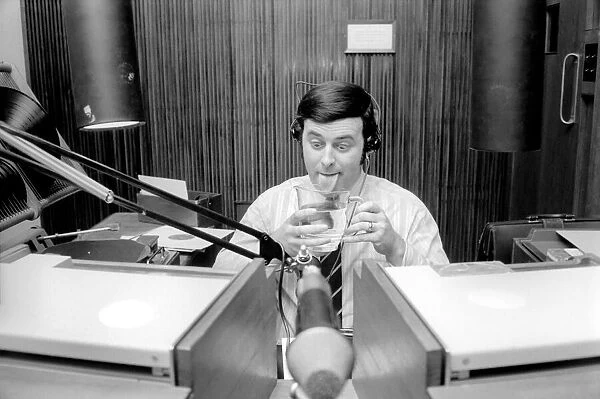 Disc Jockey Terry Wogan enjoys a large jug of water during broadcast of his afternoon