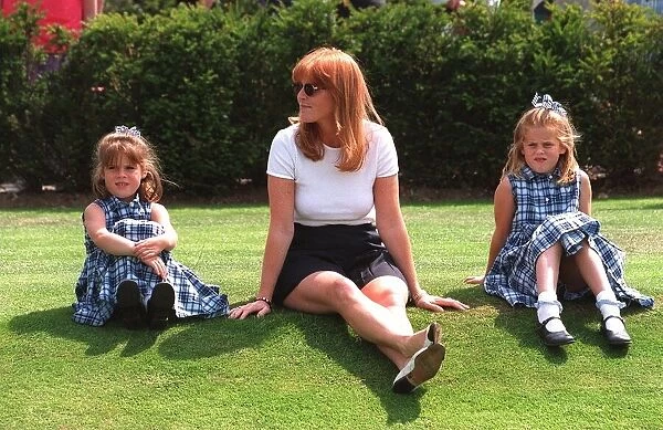 Duchess of York sits on the grass with Princess Eiugenie