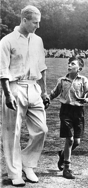 The Duke of Edinburgh. Prince Philip with an unknown child. 1950 s