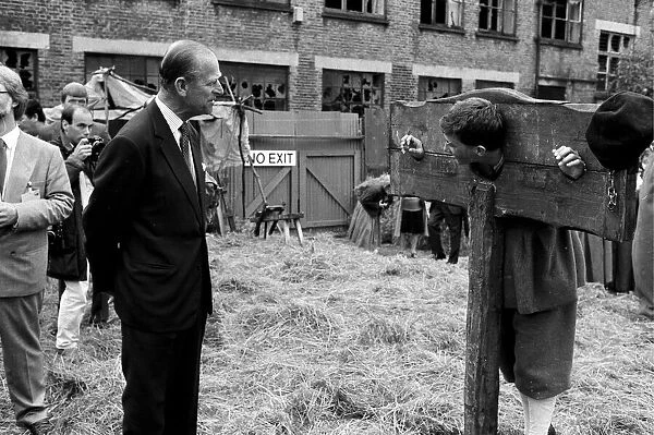 The Duke of Edinburgh visits a film set, chatting to an actor in a pillory - 17  /  7  /  1987