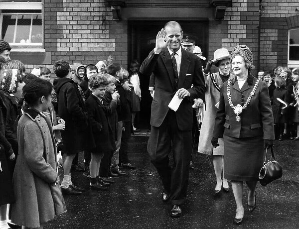 The Duke of Edinburgh walks through the lines of flag waving pupils at Kitchener Road