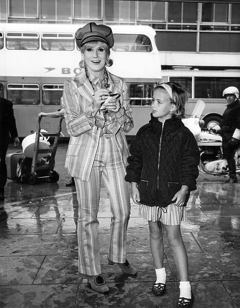Dusty Springfield pictured at London Heathrow airport signing an autograph for a young