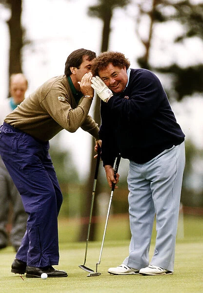 Eddie Little Comedian listens as Sevvy Ballesteros Golf whispers in his ear at a Pro