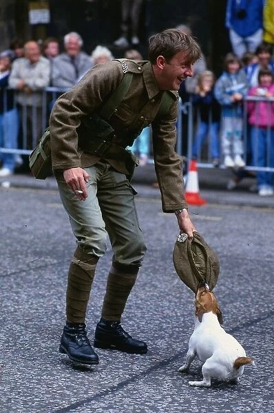 Edinburgh Festival August 1989 Dog chewing soldiers cap holding cigarette