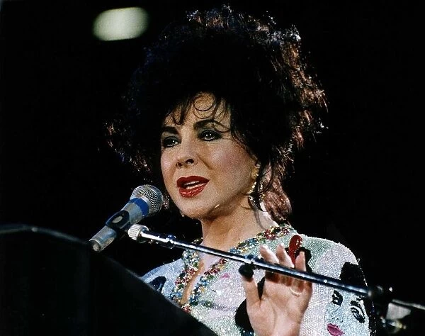 Elizabeth Taylor Actress At Freddy Mercury Aids Concert talking into mike