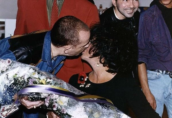 Elizabeth Taylor Actress recieves a kiss from AIDS sufferer Jan James at the London