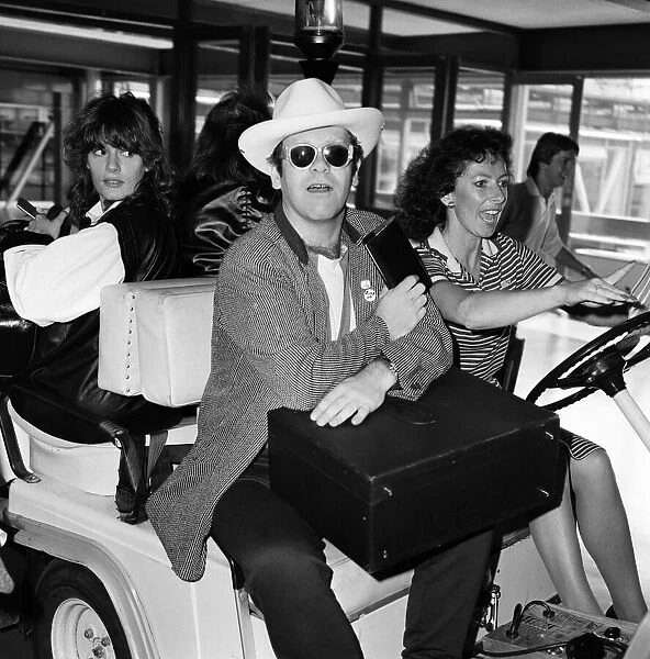 Elton John pictured at Heathrow airport. 1st June 1982