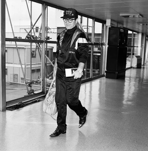 Elton John pictured at London Airport. 19th June 1987