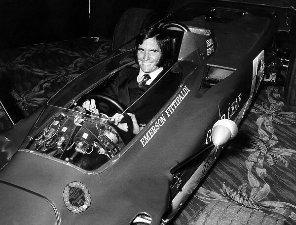 Emerson Fittipaldi formua one racing driver sits in Lotus