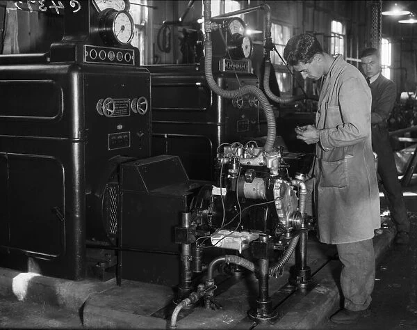 Engines being assembled at the Triumph car factory in Coventry. 23 September 1931