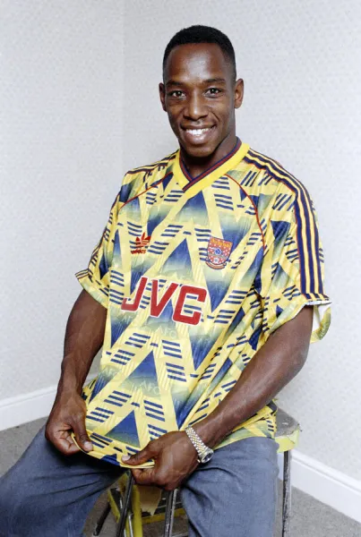 England and Arsenal footballer Ian Wright poses wearing his club sides away shirt