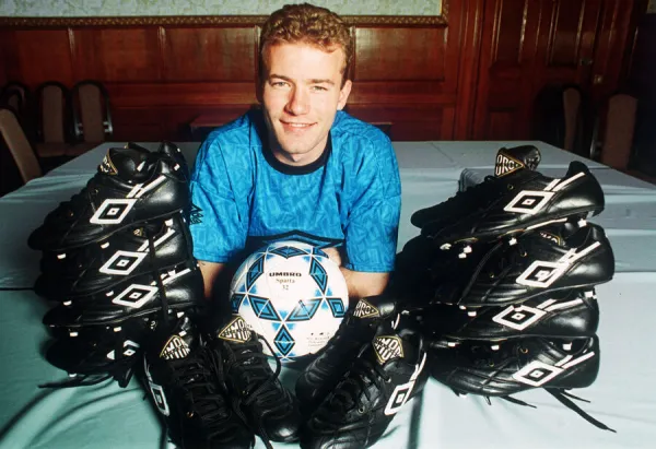 England footballer Alan Shearer footballer posing surrounded by football boots, 1992