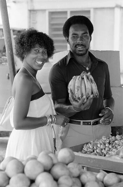England in West Indies 1981. Roland Butcher out shopping at a fruit & veg stall
