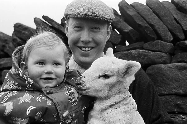 Farmer Robert Nobles and his son James with one of the spring lambs on their farm at