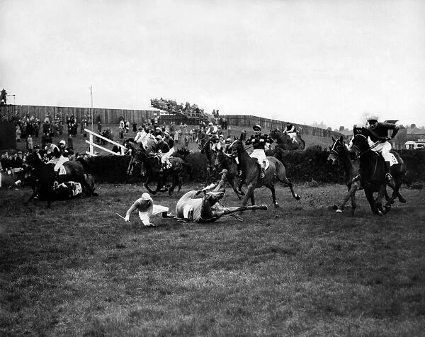 At the first fence in the 1953 Grand National Tim Moloney (white breeches