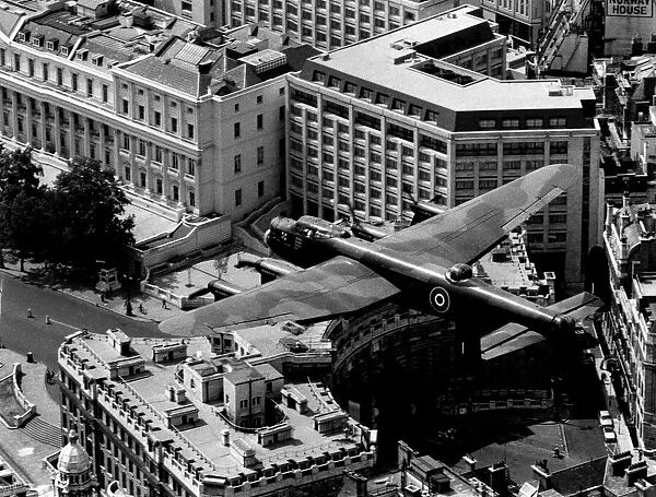 The last flying RAF Lancaster bomber over Admiralty Arch at the start of the mall in