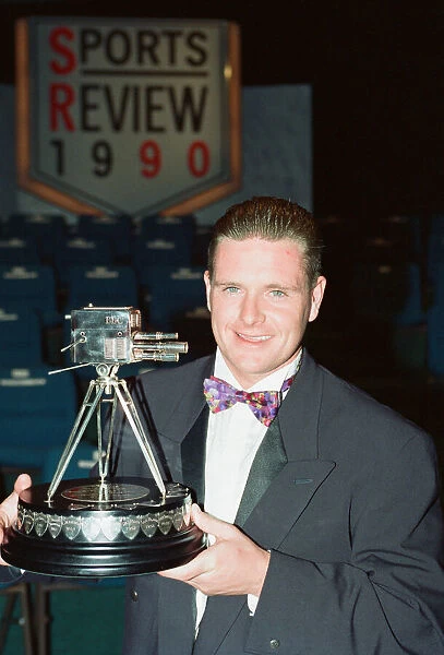 Footballer Paul Gascoigne smiles as he holds the Sports Personality of The Year award