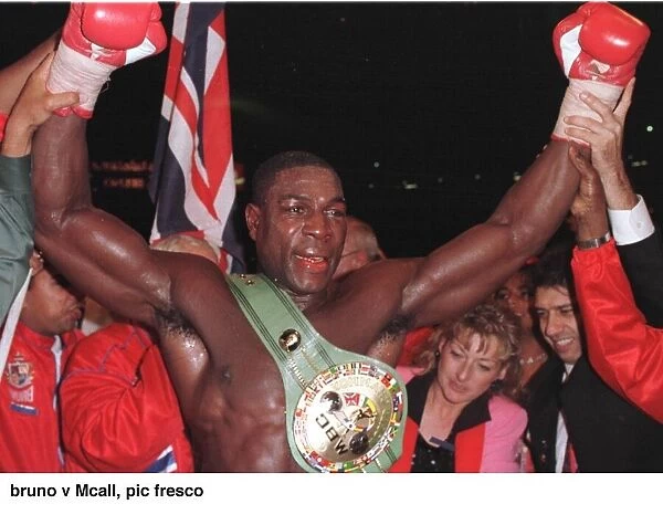 Frank Bruno raises his arms in jubilation after defeating Oliver McCall at Wembley
