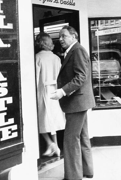 Frank Sinatra following barbara marx into a shop