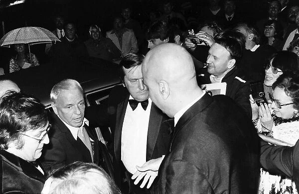 Frank Sinatra Singer and Actor flanked by bodyguards as he arrived at the Albert Hall