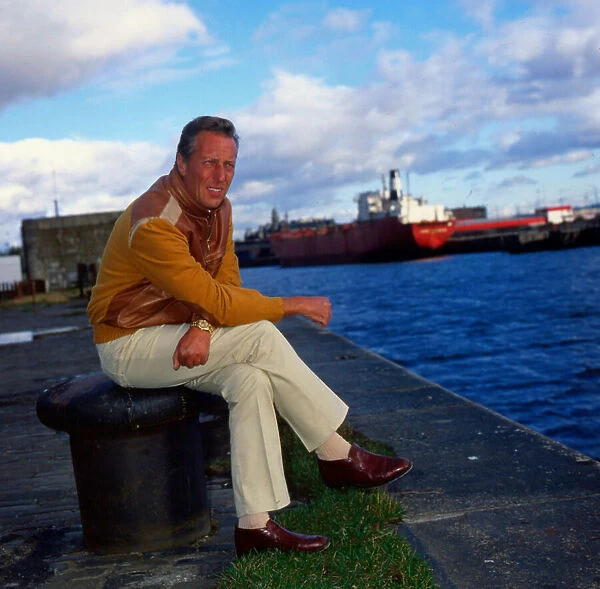 Frederick Forsyth sitting at docks September 1984