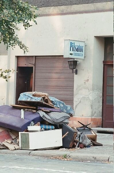 Furniture piled on street outside business which has recently closed in East Berlin