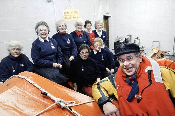Gareth Wigmore, a RNLI crew member pictured with women who helped raise money to build a