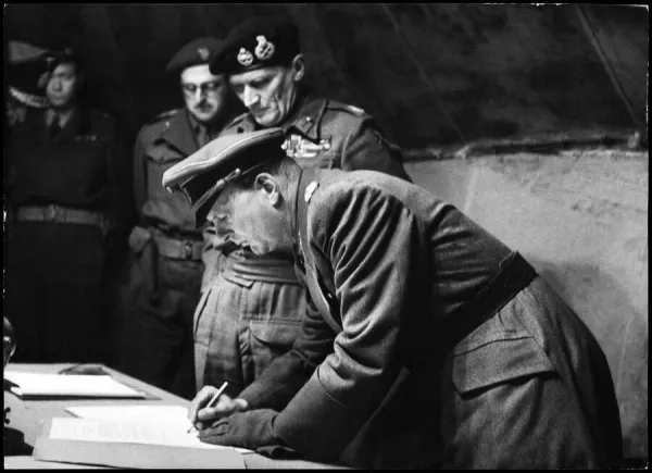 General Kinzel (German General of Infantry) puts his signature to the surrender of