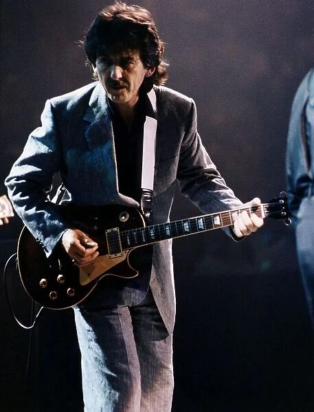 George Harrison on stage playing guitar October 1992