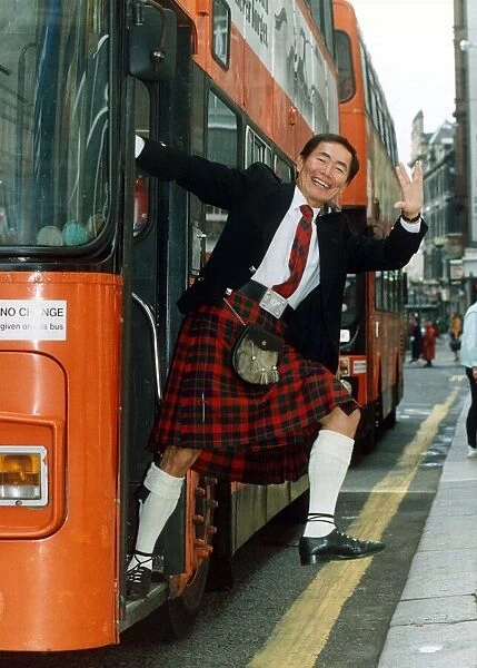 George Takei July 1992 stepping off a bus, wearing traditional Scottish clothing
