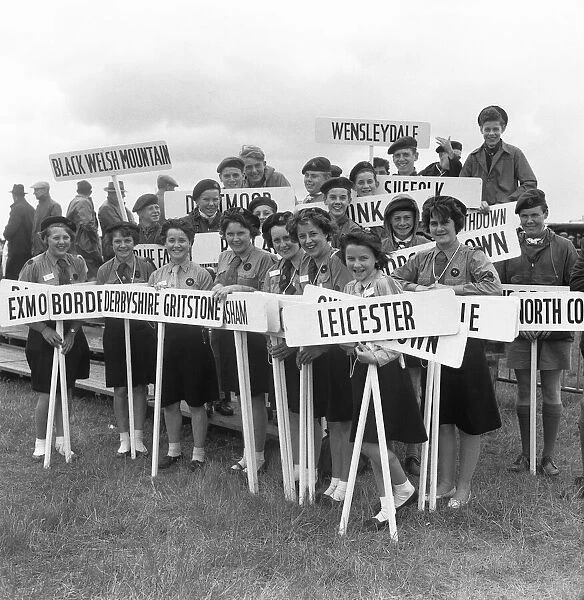 Girl Guides and Scouts holding their home town signposts at the opening of The Royal