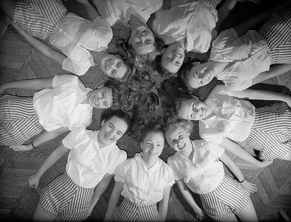 Girls of Aida Foster stage school in North London, lie down next to each other forming a