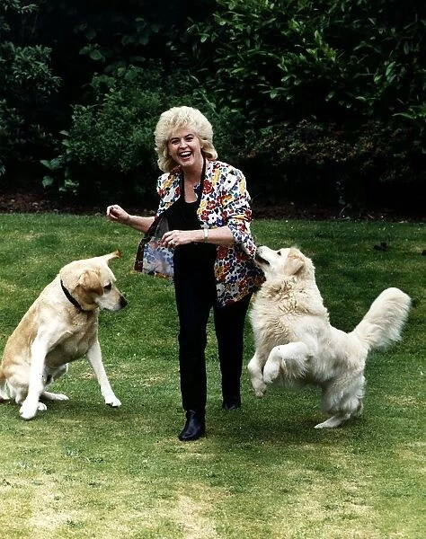 Gloria Hunniford TV Presenter in garden with dogs