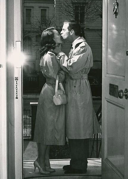 Goodnight kiss on the doorstep: Ian Carmichael and Janette Seatt exchange a tender kiss