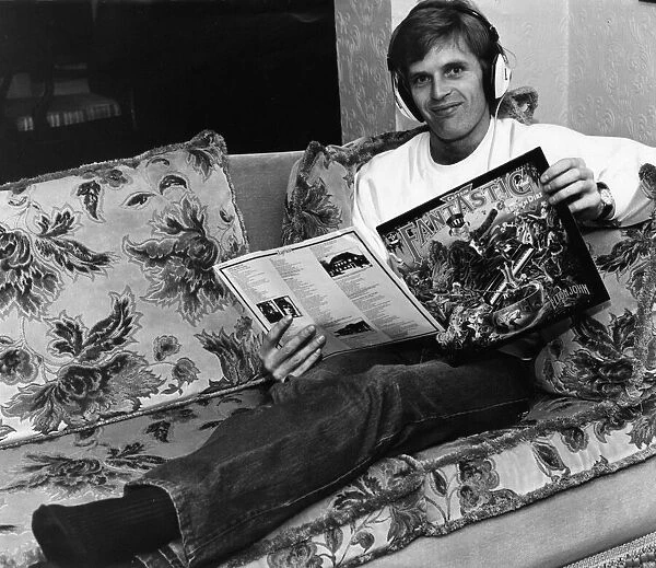 Gordon McQueen, Manchester United defender, with a copy of Elton Johns album