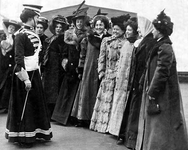 A group of ladies all wearing long coats and hats during an inspection for Whitehall