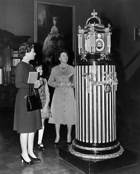 H. M. The Queen H. R. H. Princess Margaret, and Lady Sarah Armstrong Jones looking at a four