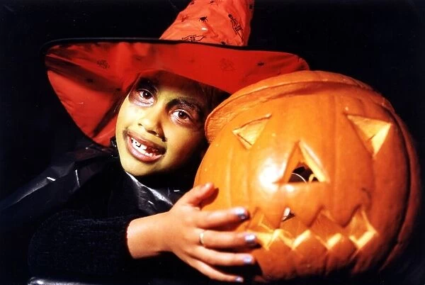 Halloween - Shiran Shah, six, dressed up as a witch with her pumpkin a St Monica