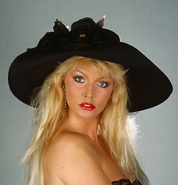 Hat fashion model wears black silk hat with roses April 1990