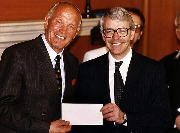 Henry Cooper (L) ex-British and Commonwealth Heavyweight boxing champion receives a