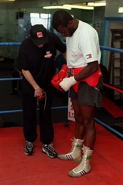 Herbie Hide Boxer putting on boxing gloves with his trainner Jim Mcdonnell