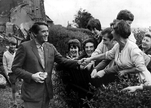Hollywood filmstar Gregory Peck shakes hands with delighted residents of Crumlin on his