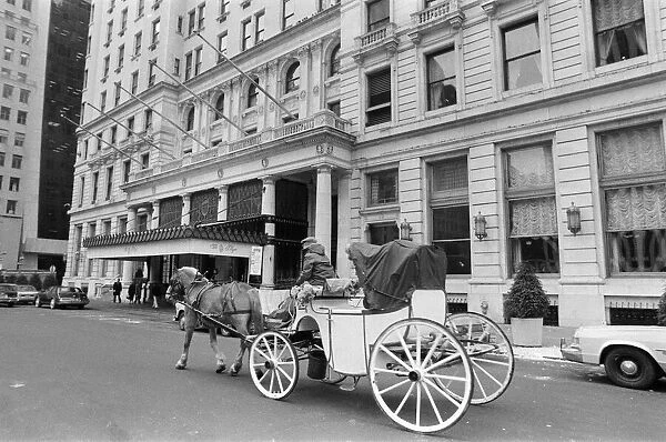 A horse drawn carriage riding past The Plaza Hotel. New York, 13th February 1981
