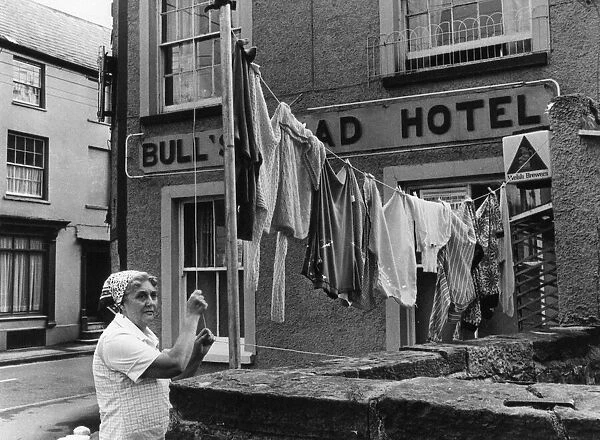 Hotel Landlady Mrs Maureen Roach puts up another line of washing outside the Bull