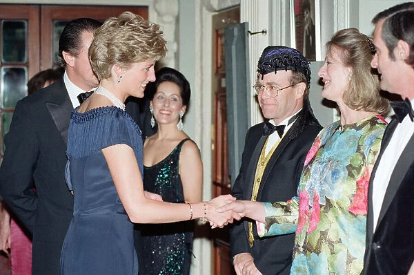 HRH Princess Diana, Princess of Wales is greeted by guests including singer Elton John