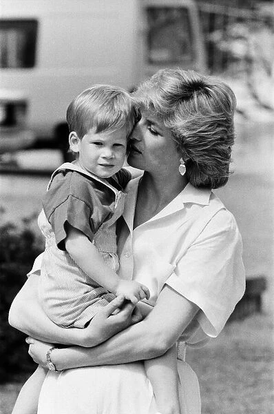 HRH Princess Diana, The Princess of Wales holds her young son Prince Harry on holiday in