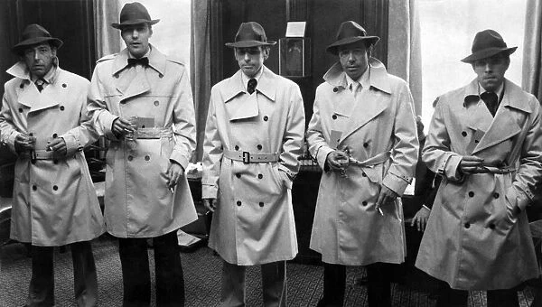 Humphrey Bogart look a like competition. Competition entrants in their Bogart raincoats